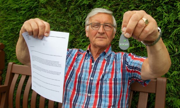 Bob Tennant with his Energie Fitness Dundee pass and an email from the club owner saying the business has closed.