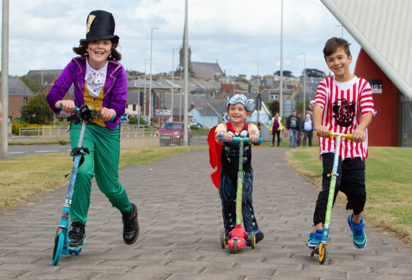 Safiyyah Mallick,10, Ilyas Mallick, 8, and Yahya Mallick, 4, heading for the finish line on their scooters. 