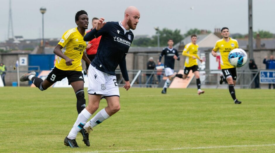 Zak Rudden chips the goalkeeper to put Dundee 1-0 up in a friendly at Peterhead.