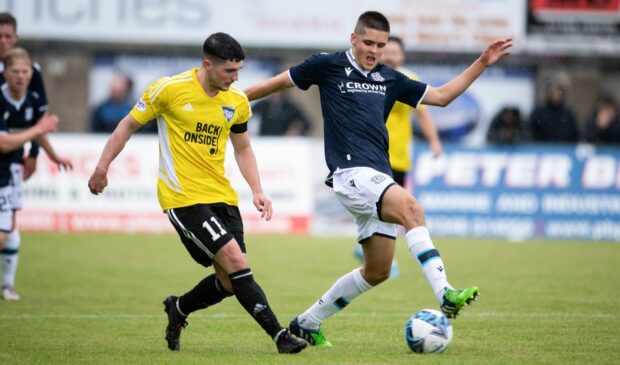 Dundee's Callum Lamb (R) takes on Peterhead's Jack Brown.