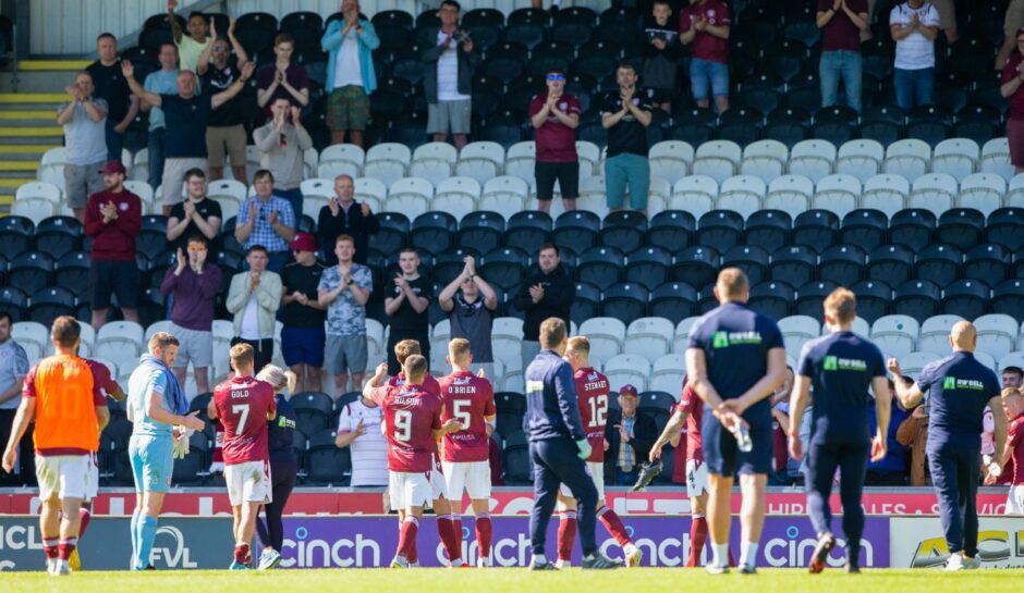 The Arbroath players celebrate with their fans at full-time.