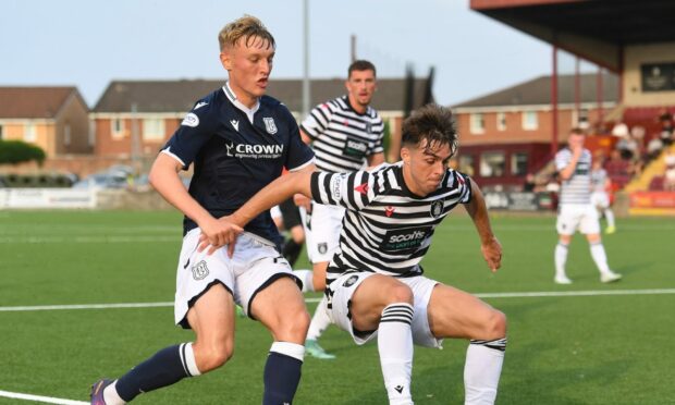 Dundee's Max Anderson puts pressure on Queen's Park's Grant Savoury.