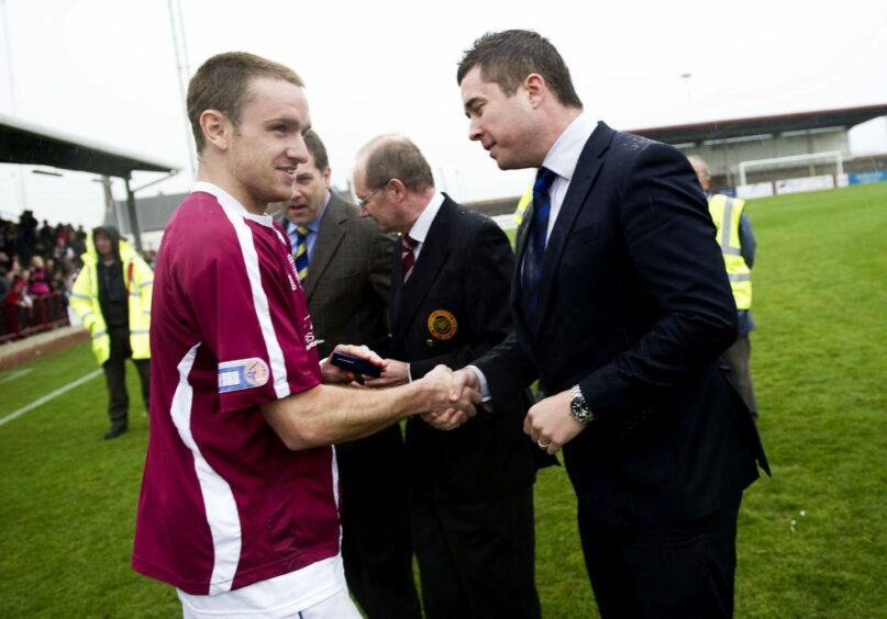 Adam Strachan receiving his League Two winner's medal with Arbroath.
