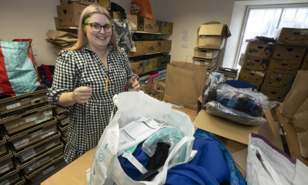 Rachael Esdale is pictured packing up school uniform packs.