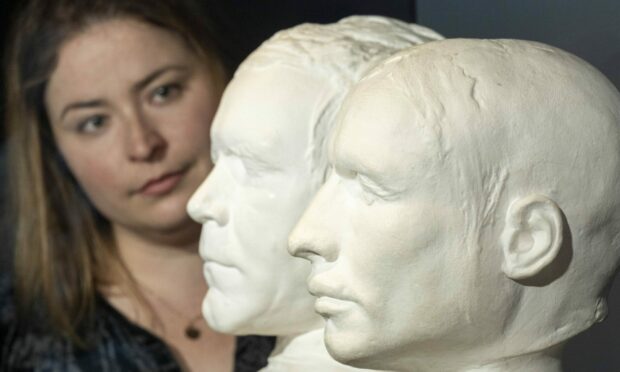 Curator Sophie Goggins with the life masks of mass murderers Burke and Hare, on loan from the Anatomical Museum collection, University of Edinburgh