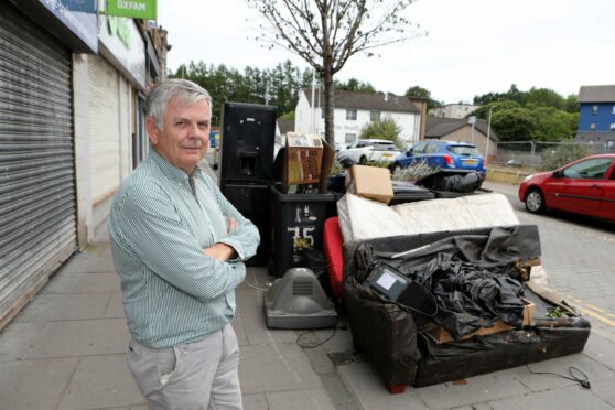 Councillor Charlie Malone with the flytipping on The High Street, Lochee. Pic Gareth Jennings.