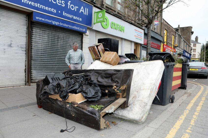 Charlie Malone with the household goods dumped. Pic Gareth Jennings.