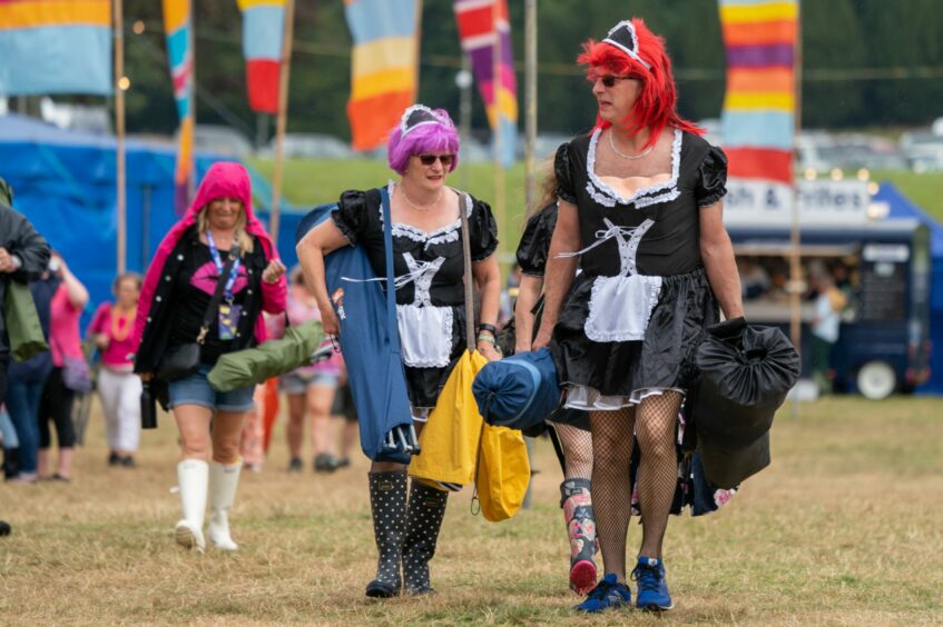 Rewind Scotland festival goers in French made costumes, fishnets and trainers and wellies.