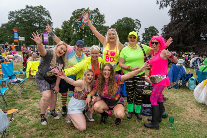 Group of music fans in colourful 80s fashions at Rewind festival at Scone in 2022.