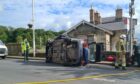 A car has flipped on its side by Markinch train station.