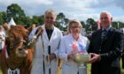 TOP PRIZE: Beef interbreed judge Andrew Reid presents the cup for the top show award to the Robertson family from Fodderletter, Tomintoul.