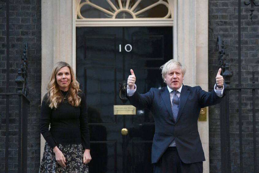 Thumbs up from Boris and Carrie. Thumbs down from party colleagues who forced the PM's resignation last week: Victoria Jones/PA Wire.