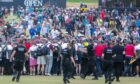 Crowds rush the 18th fairway as the event reaches its conclusion.