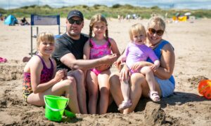The Clark family enjoy a sunny day out at St Andrews West Sands beach.