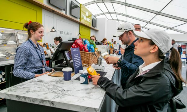 Spectators buying snacks in The Slice, one of the takeaways at The Old Course. Picture Steve Brown/DCT Media.