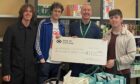Shambolics present £1200 from their recent fundraiser to Kirkcaldy Foodbank. Pictured (left to right), Lewis McDonald, Darren Forbes, Ian Campbell of Kirkcaldy Foodbank and Scotty Paws.