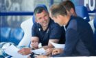 Callum Daivdson (left) discusses plans pre-match at Queen of the South with St Johnstone coaches Steven MacLean and Alec Cleland