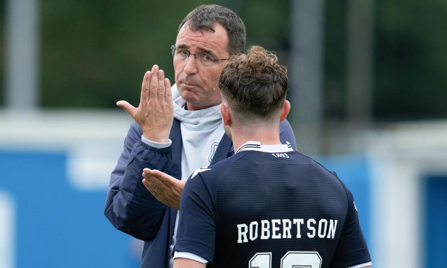 Dundee boss Gary Bowyer in conversation with midfielder Fin Robertson after full-time at Stranraer.