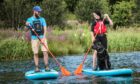Lead instructor Sam Garthwaite and Gayle with her dog Toby on the paddleboards.