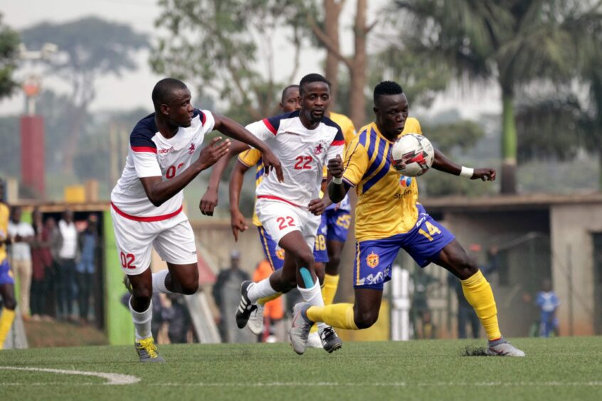Sadat Anaku of KCCA FC, right, controls the ball on his chest.