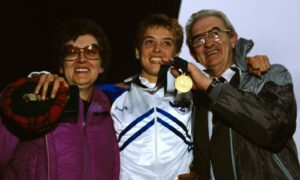 Liz Lynch celebrates winning gold for the 10,000 metres in the Commonwealth Games with her parents.