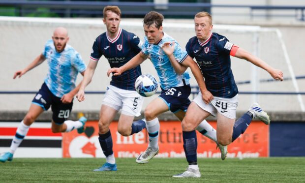 Dundee's Josh Mulligan takes on Raith Rovers.