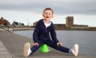 Zander Smith, six, sitting 'Oor Wullie' style atop his bucket at Broughty Ferry.