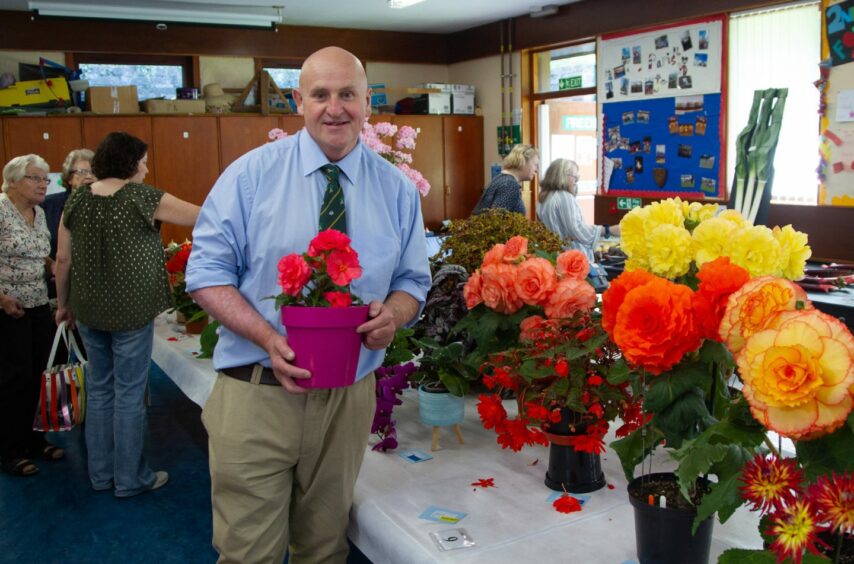 Chairman David Nelson with some of the winning begonias. Pic: Paul Reid.
