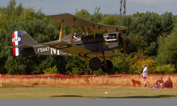 A replica First World War biplane about to touch down at the Broomfield site. Picture: Paul Reid.