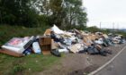 Huge piles of rubbish dumped at Riverside recycling centre in Dundee. Image: Paul Reid.