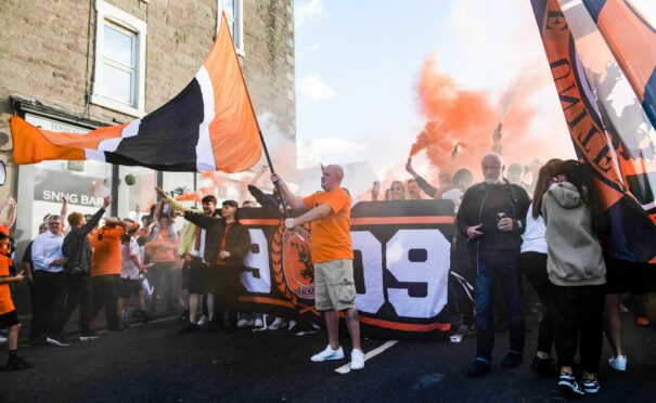 Dundee United fans gather outside the Snug Bar ahead of their corteo march to Tannadice.
