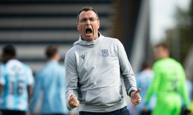Dundee manager Gary Bowyer celebrates in front of the Dundee support after beating Raith Rovers.