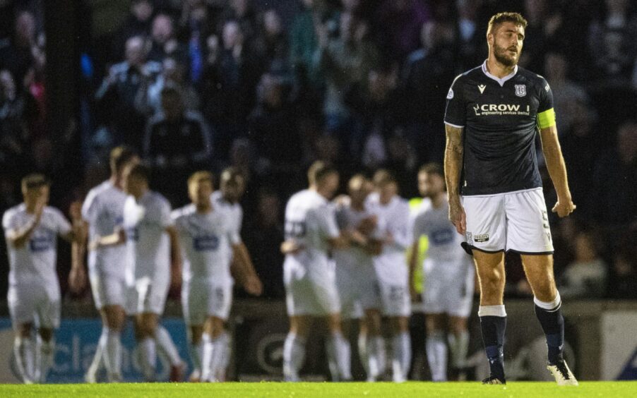 Ryan Sweeney is dejected as Ayr celebrate in the background