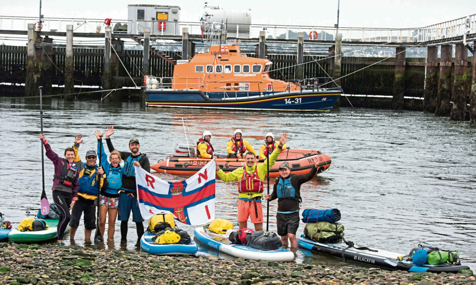 (L-R) Casey Millar, Steve Haden, Avril Muir, Dave Ashall, Euan Stewart and Mike Hammond with the inshore lifeboat crew and the off shore lifeboat.