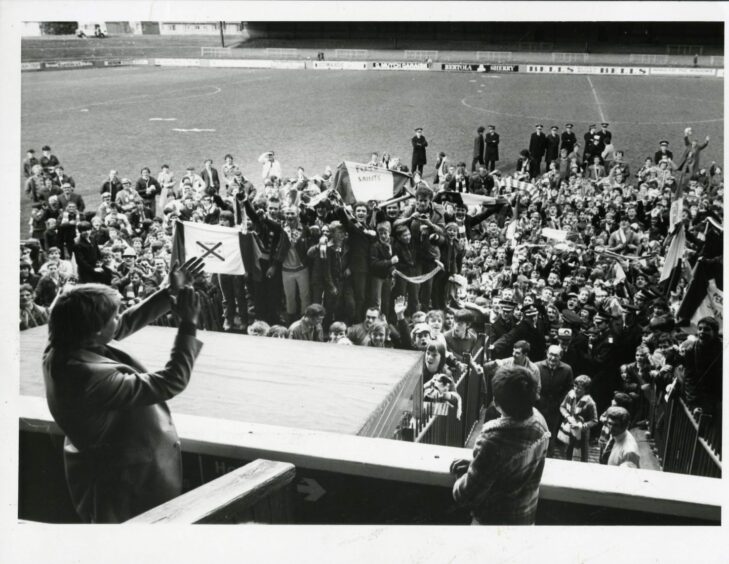 St Johnstone fans celebrate the title win in front of manager Alex Rennie.