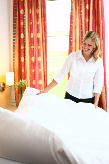 A photo of a member of housekeeping staff at the University of St Andrews