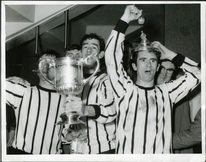 Willie Callaghan wearing the Scottish Cup on his head with brother Tommy looking on.