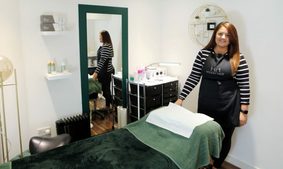 Emma standing behind a massage table in the Diamond Beauty Zone salon