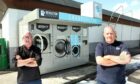 Club officials Colin Lamb and Danny McGregor beside the vandalised washing machines.