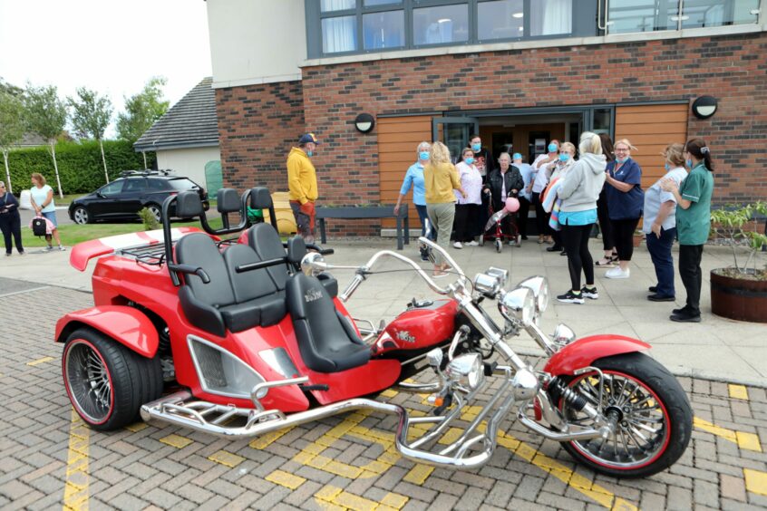 Kit emerging from Monkbarns Care Home to see the trike.