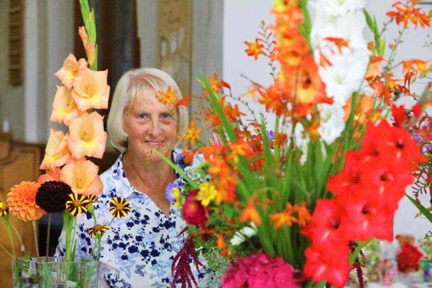 Show secretary Christine Russell with the gladioli.