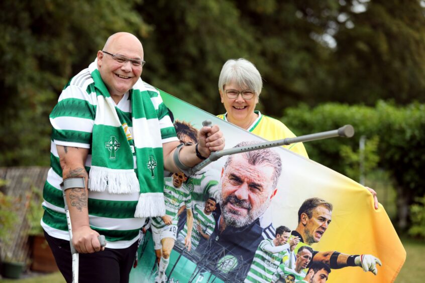 Steven and Yvonne Pert with Celtic tops, scarf and flag.