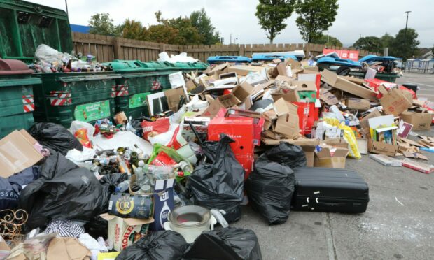 Rubbish piled high at a recycling point outside the Tesco Kingsway store in Dundee.