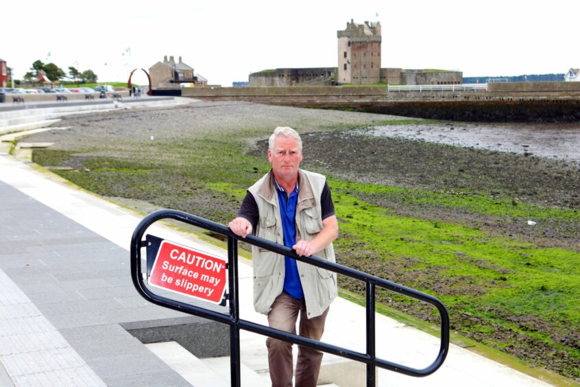 Councillor Craig Duncan at the new steps at Broughty Ferry Beach where hand rails have now been installed to prevent slips.