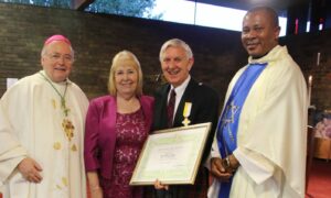 Bill and Helen Flight at the medal presentation with Bishop of Dunkeld Stephen Logan (left) and Father Tobias Okoro of St Fergus.