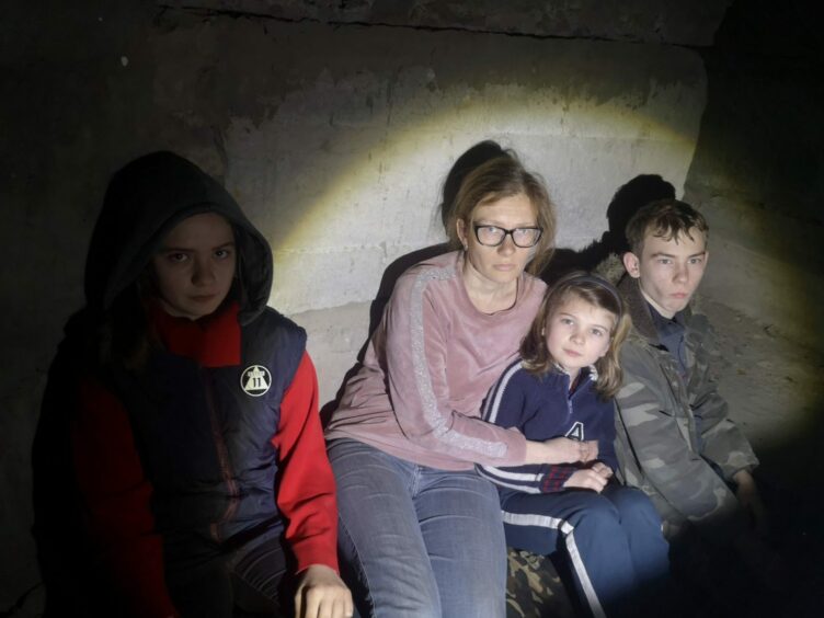A young family hiding in a bunker during the war in Ukraine