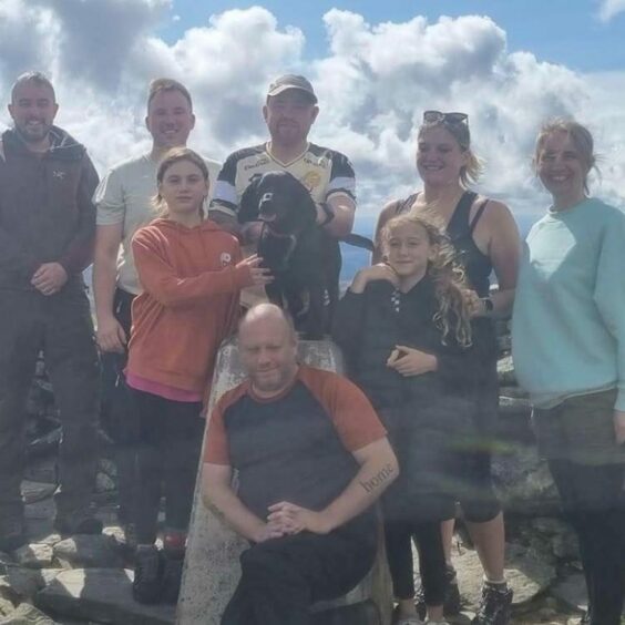 Family and friends joined James (centre back) for the final climb up Driesh in the Angus glens.