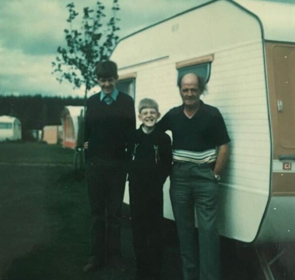 John Morrison, centre, with his dad and elder bro