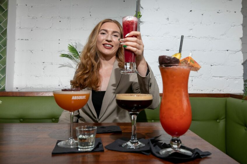 Perth Cocktail Week organiser Alice Christison in front of a row of cocktails