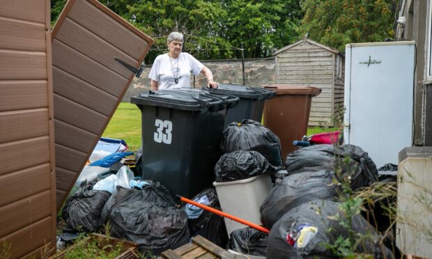 Sarah Valentine with the rubbish outside her home.